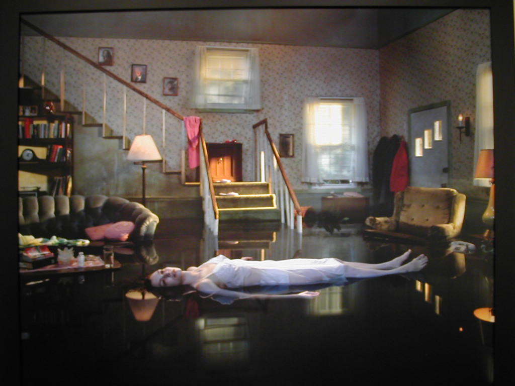 A girl floating in her flooded house.